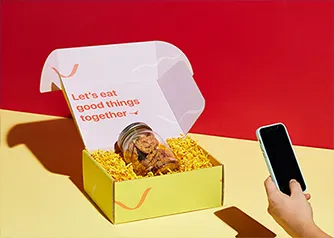 Open custom yellow mailer box with cookie jar inside and branded interior